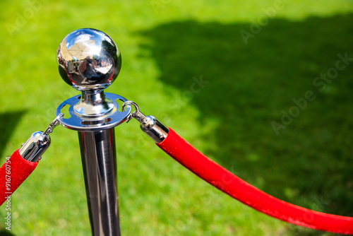 Elegant Silver Stanchions with Red Velvet Rope Forming a Regal Barrier