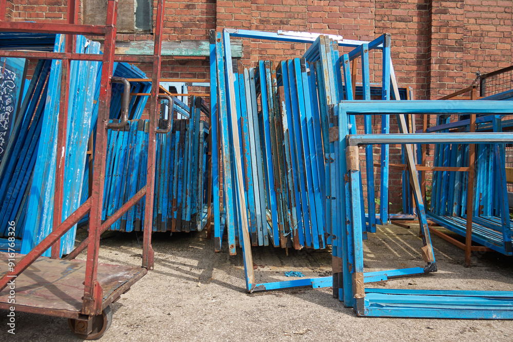 Silk screen printing screens stored in a outdoors in a metal rack ready for printing. Replacing and repairing old screen print retro vintage printmaking. Artists screen printing. Silk screen printing screens stored in a outdoors in a metal rack ready for printing. Replacing and repairing old screen print retro vintage printmaking. Artists screen printing.