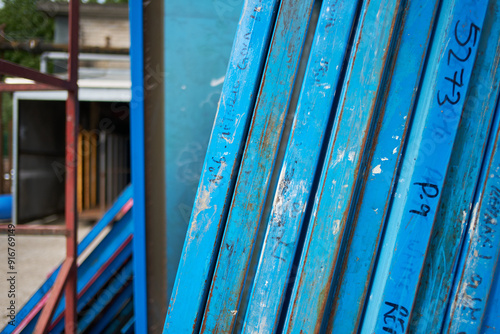 Silk screen printing screens stored in a outdoors in a metal rack ready for printing. Replacing and repairing old screen print retro vintage printmaking. Artists screen printing.