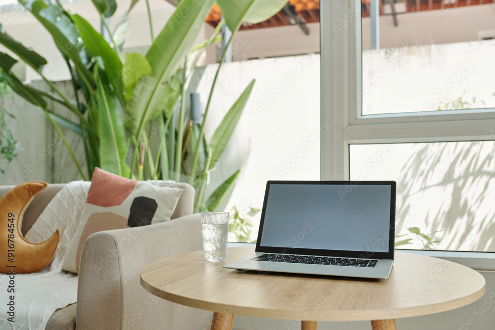 Laptop for online work on coffee table in the living room Laptop for online work on coffee table in the living room