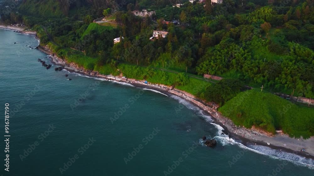 aerial shot view of the sea coast with the area completely covered with greenery drone view of the sea coast from a bird's eye view the camera moves away and turns to the right Tsikhisdzirits Georgia aerial shot view of the sea coast with the area completely covered with greenery drone view of the sea coast from a bird's eye view the camera moves away and turns to the right Tsikhisdzirits Georgia
