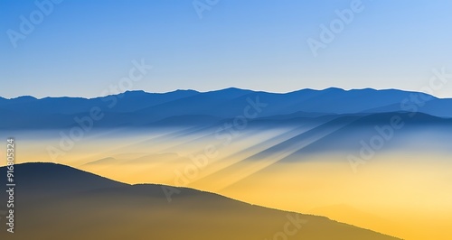 Sunrise over a mountain range with a sea of clouds below. The sky is a deep blue with hints of orange and yellow.