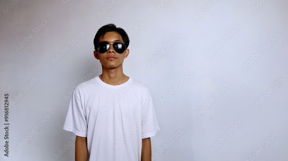 Asian male youth flat expression wearing white shirt and sunglasses Asian male youth flat expression wearing white shirt and sunglasses