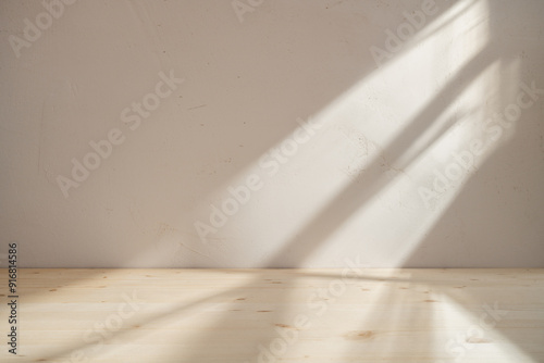 Empty wooden table on stucco background with light and window shadow on the wall. Mock up for branding products, presentation, food and health care.	
