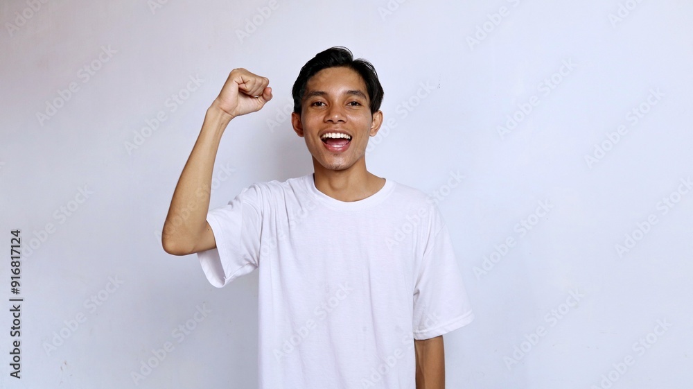 young asian man excited clenching both hands expression happy, happy, winning, celebration young asian man excited clenching both hands expression happy, happy, winning, celebration