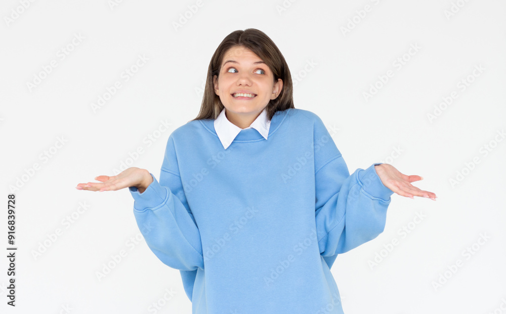 Confused thoughtful confused brunette young woman holding copy space on palm over white background Confused thoughtful confused brunette young woman holding copy space on palm over white background