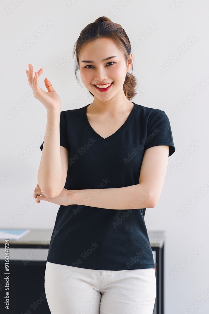 Cheerful asian woman smiles while gesturing with open hands presenting or explaining something. Cheerful asian woman smiles while gesturing with open hands presenting or explaining something.