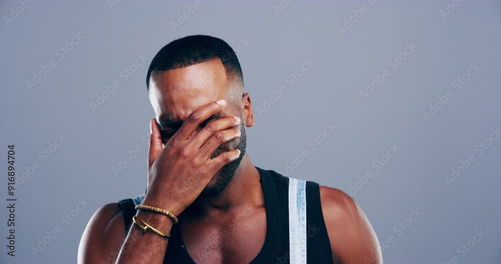 Depression, crying and face of black man in a studio with upset, worry and sad expression. Emotions, grief crisis and portrait of young African male person with tears isolated by gray background.
