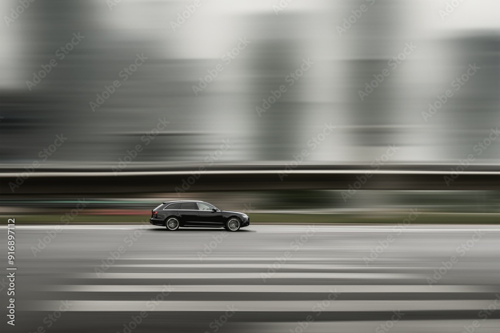 Fast driving car. Black car with city background blurred at speed. Car driving, speed concept Fast driving car. Black car with city background blurred at speed. Car driving, speed concept