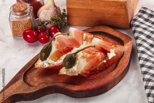 Bruschetta with jamon and caper berries photo