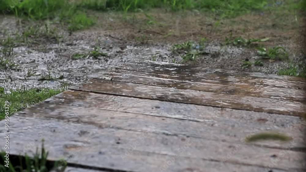 Wooden floor deck background with rain drops. Selective focus. Raindrops splashing on a wooden floor Wooden floor deck background with rain drops. Selective focus. Raindrops splashing on a wooden floor