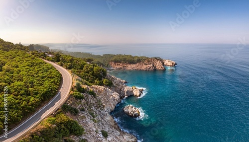 Aerial view of a winding coastal road-_A coastal road curving along cliffs, with the ocean