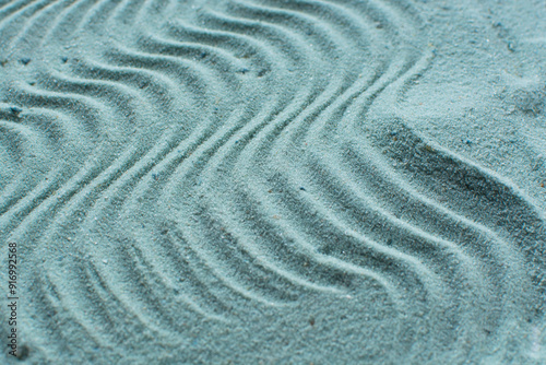 textured blue sand background, beautiful sand texture, overhead view of blue sand, zen pattern drawn in the sand, Top view of fine grain texture