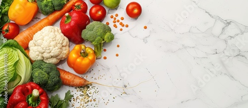 Fototapeta Naklejka Na Ścianę i Meble -  Fresh vegetables fruits and grains providing protein for vegetarians displayed on a white marble surface with ample copy space for a banner design