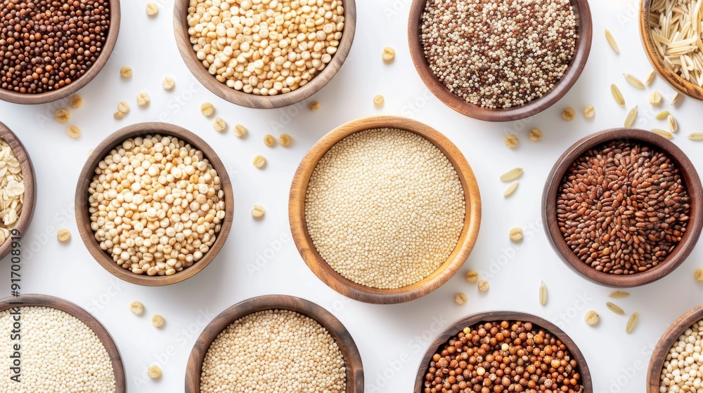 A close-up of various whole grains including quinoa, brown rice, barley, and millet, each in a separate small bowl. A close-up of various whole grains including quinoa, brown rice, barley, and millet, each in a separate small bowl.