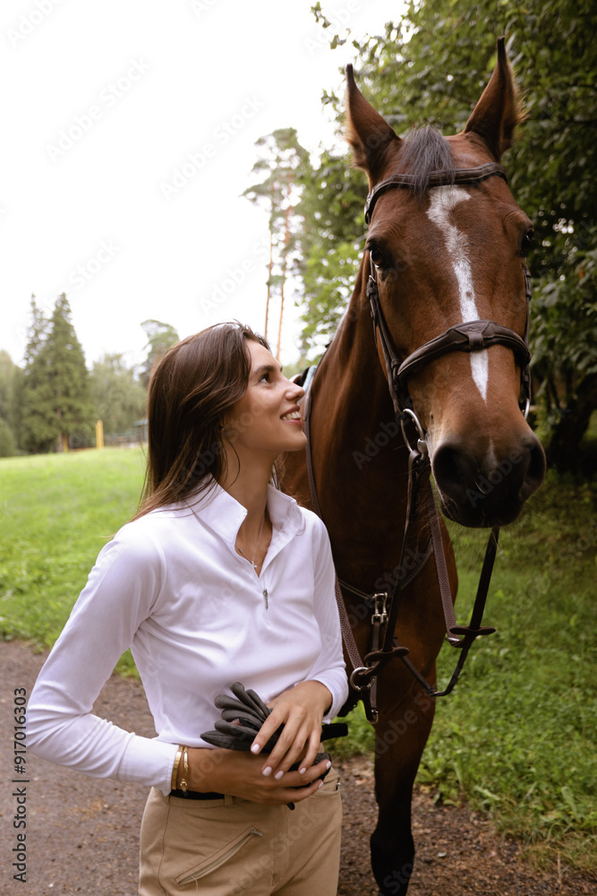 Fototapeta premium beautiful woman with dark hair posing with horse
