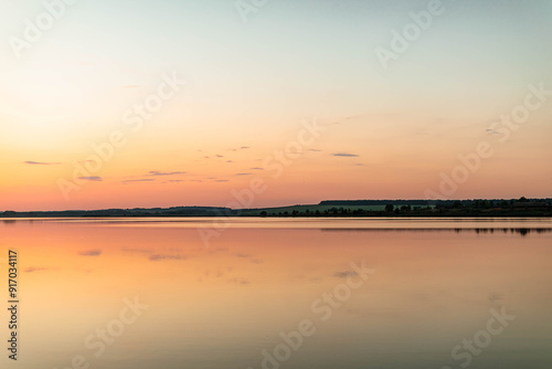 Sunset on the river. Reflection on the water.