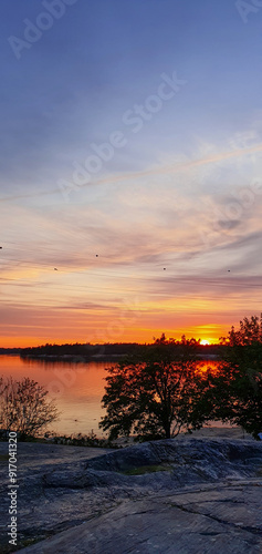 beautiful sunset in orange intensive colors in hietaniemi beach in helsinki finland photo