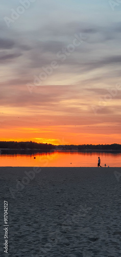 beautiful sunset in orange intensive colors in hietaniemi beach in helsinki finland photo