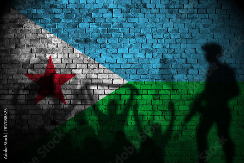 djibouti flag on brick wall and protesters shadow photo