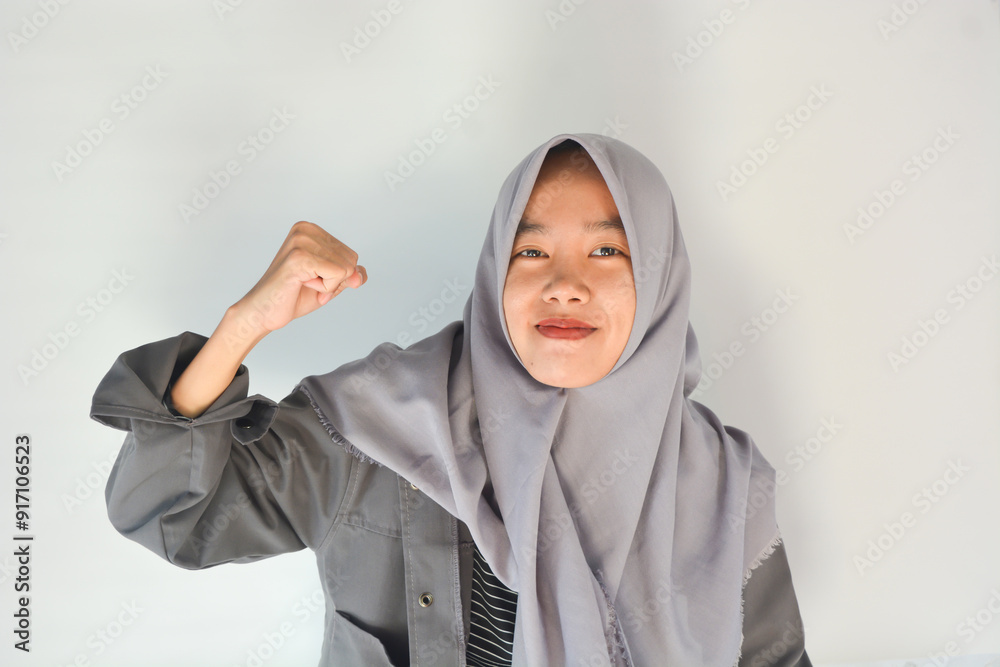 Strong woman in casual clothes smiling over isolated background showing her muscles Strong woman in casual clothes smiling over isolated background showing her muscles