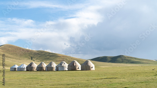 Traditional yurt camp at the Song Kul lake plateau in Kyrgyzstan, showcasing the nomadic lifestyle with portable felt tents used as accommodations.