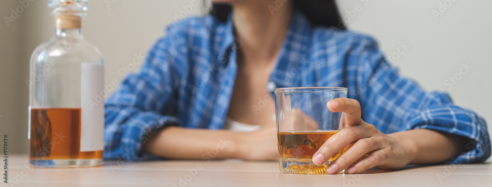 Alcoholism drunk, sad asian young woman hand holding glass of alcohol or whiskey, alone depressed female drink booze on background. Treatment of alcohol addiction, suffer abuse problem alcoholism. Alcoholism drunk, sad asian young woman hand holding glass of alcohol or whiskey, alone depressed female drink booze on background. Treatment of alcohol addiction, suffer abuse problem alcoholism.