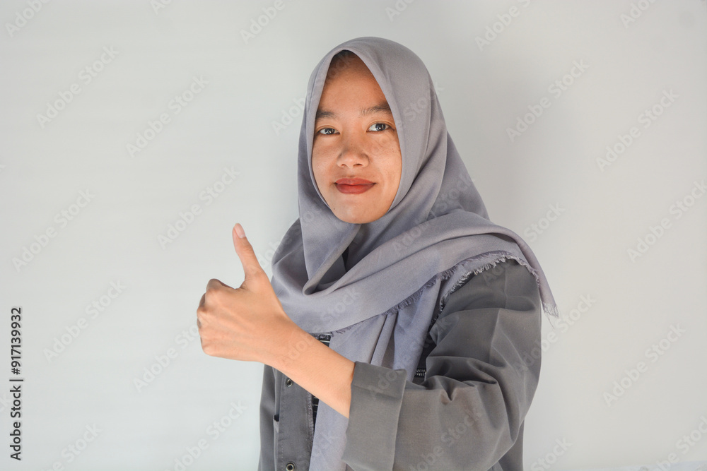 Young cheerful happy smiling pleasant successful employee business woman in her 20s wearing casual brown classic jacket showing okay okay gesture isolated on plain pastel light pink background studio Young cheerful happy smiling pleasant successful employee business woman in her 20s wearing casual brown classic jacket showing okay okay gesture isolated on plain pastel light pink background studio
