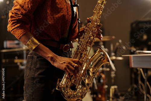 Photography Close-up of person playing saxophone, capturing the energy and focus during perf