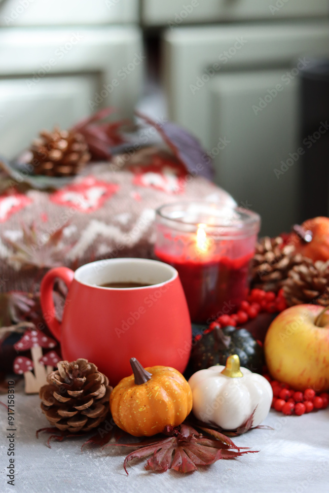 Autumn composition with cup of coffee, autumn leaves, red berries, pumpkins and knitted sweater Autumn composition with cup of coffee, autumn leaves, red berries, pumpkins and knitted sweater