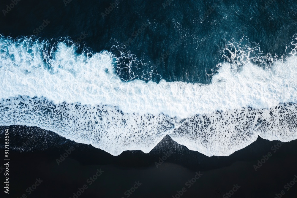 Obraz premium aerial top down view of beautiful white blue water waves splashing over dark beach, ai