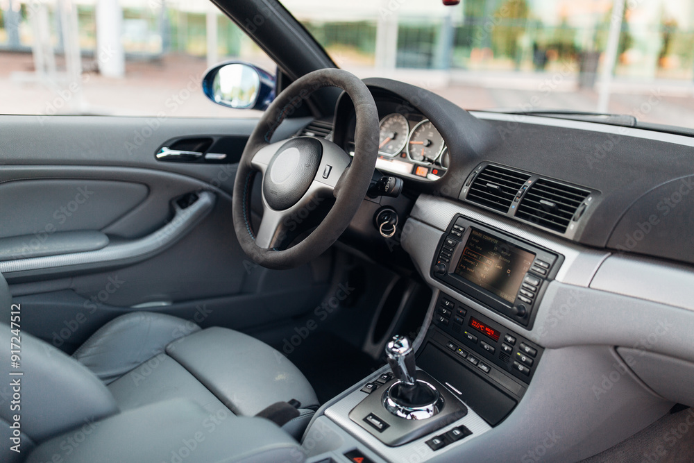 Interior of car with leather seats big multimedia monitor dashboard and control panel view from rear seat row Interior of car with leather seats big multimedia monitor dashboard and control panel view from rear seat row