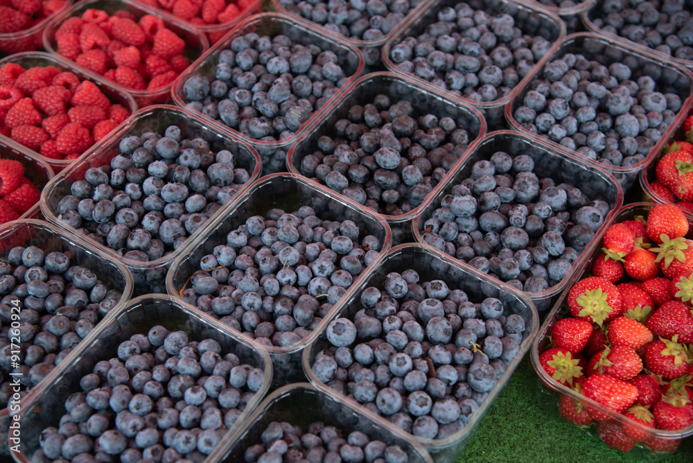 Fresh ripe blueberries and strawberries for sale in a fruit market. Fresh ripe blueberries and strawberries for sale in a fruit market.