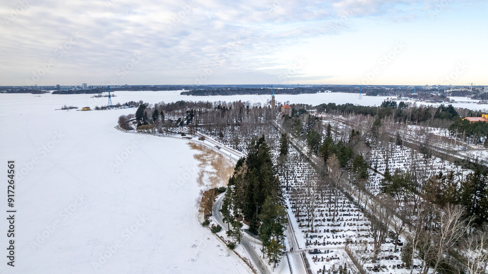 Obraz premium drone aerial view over Helsinki sea line in winter time - beach and marina covered with snow