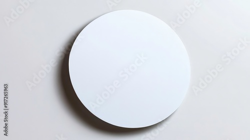 A white circle with a soft shadow cast on a white background.