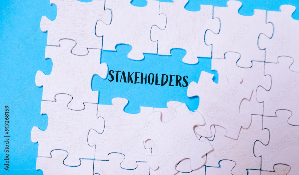 A jigsaw puzzle with the word stakeholders written in the middle A jigsaw puzzle with the word stakeholders written in the middle