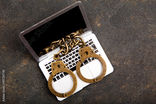 image of miniature computer handcuffs