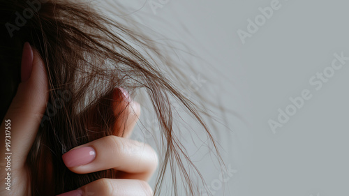 Brittle, dry hair. Woman holds her hair in her hand.  photo