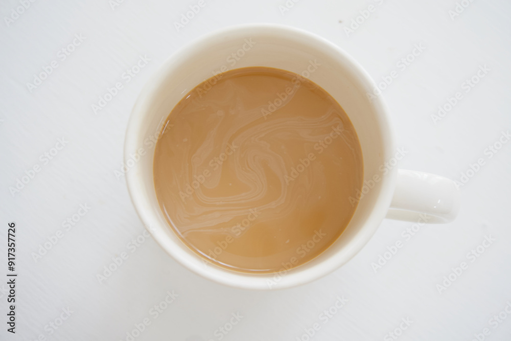 Hot coffee with creamer swirling inside mug Hot coffee with creamer swirling inside mug