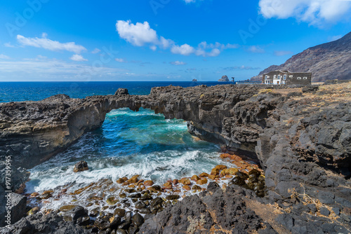rocky beach with a natural arch in Las Puntas. El Hierro island. Canary Islands