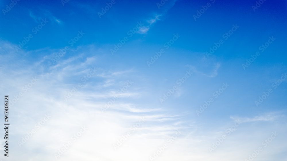 Clear blue sky with soft white clouds symbolizing tranquility, perfect for spring or summer backgrounds, and nature-related concepts Clear blue sky with soft white clouds symbolizing tranquility, perfect for spring or summer backgrounds, and nature-related concepts