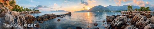 Rocky coastline and mountains at sunset in a serene landscape