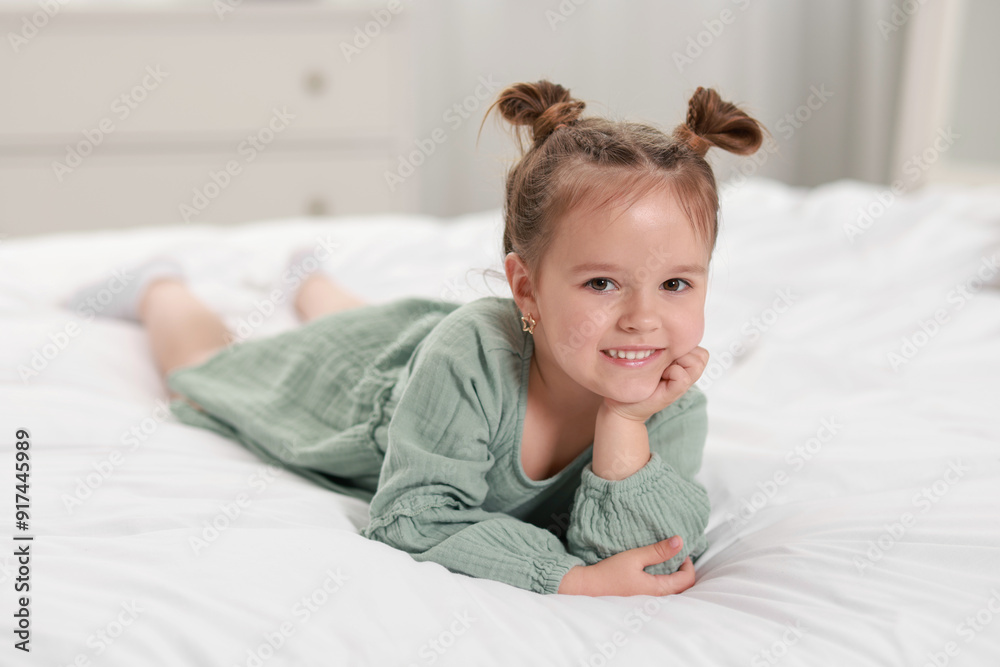 Portrait of happy little girl on bed at home Portrait of happy little girl on bed at home