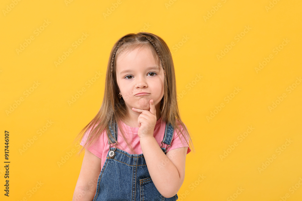 Portrait of cute little girl on orange background Portrait of cute little girl on orange background