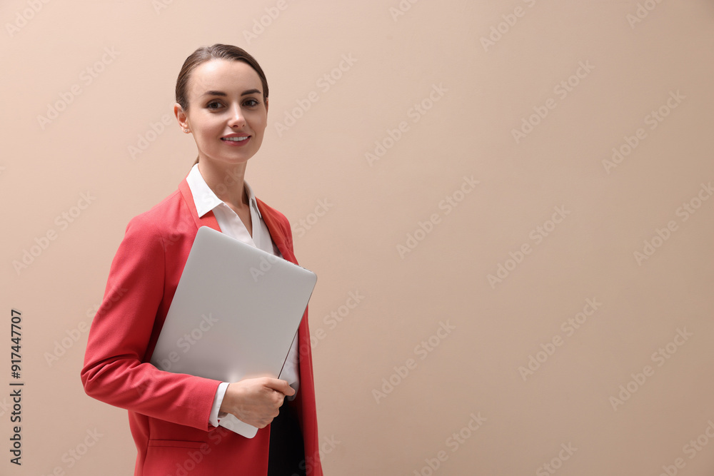 Portrait of smiling businesswoman with laptop on beige background. Space for text Portrait of smiling businesswoman with laptop on beige background. Space for text