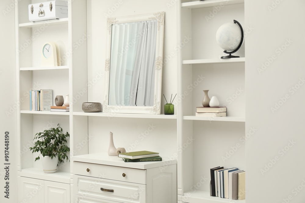 Fototapeta premium Mirror on white shelf in room. Interior design