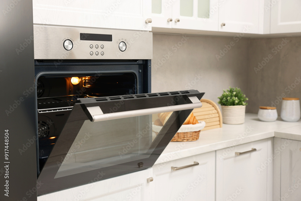 Fototapeta premium Open electric oven in kitchen. Cooking appliance