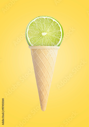 Ice cream cone with lime on yellow background