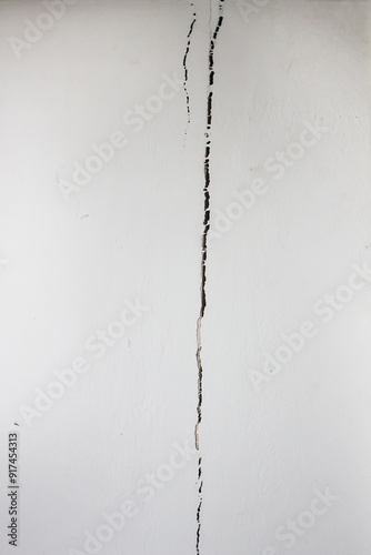 Cracked cement wall caused by house collapse.