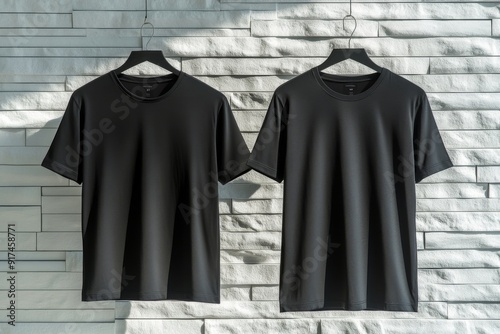 Here's a mockup of a black blank t-shirt with a white wall and a front and back view. Please replace the design with your own.